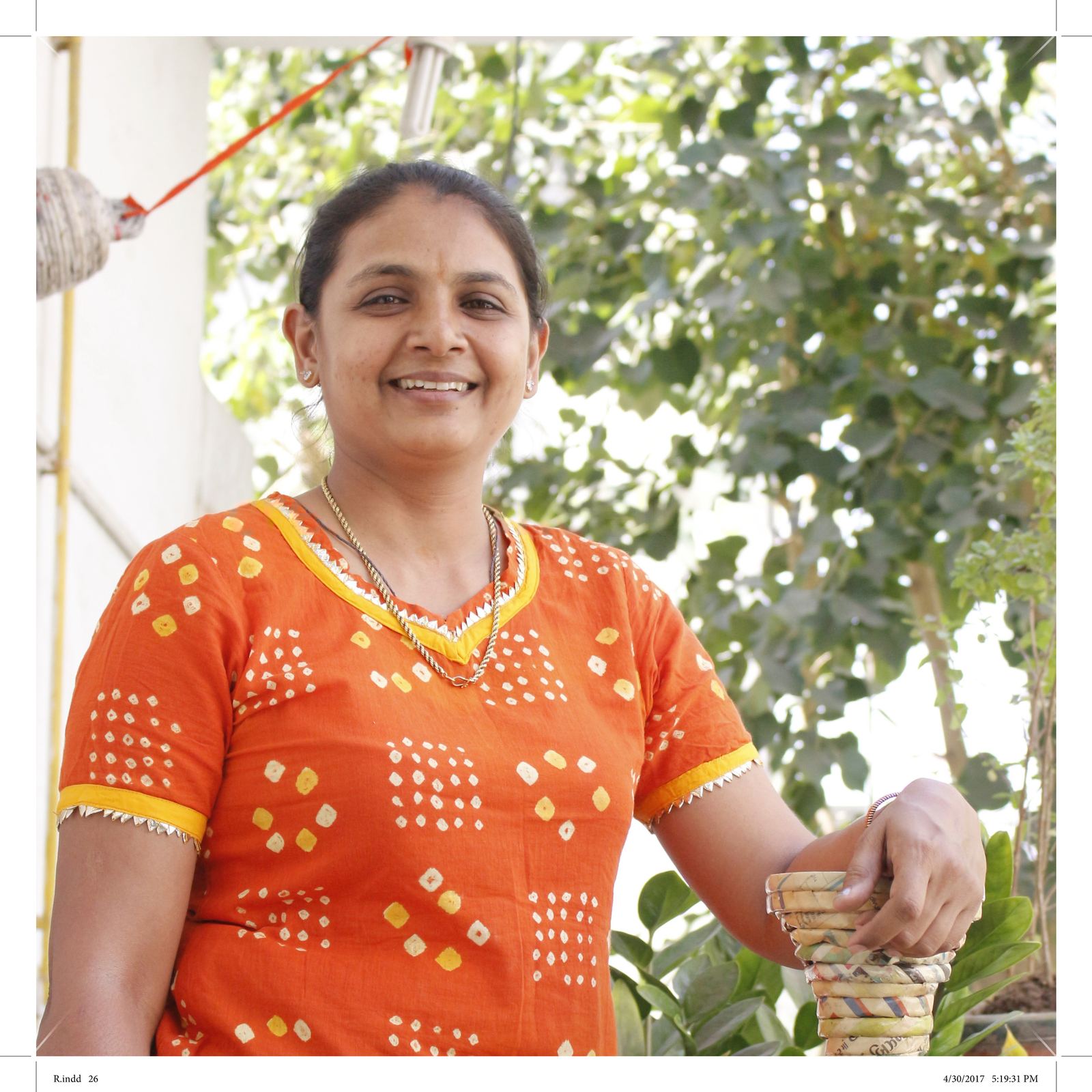 Neelu Patel with a paper roll art piece